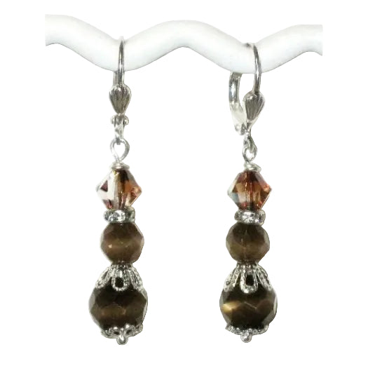 Pair of dangle earrings with brown beads that hang on silver-plated leverbacks on a white background