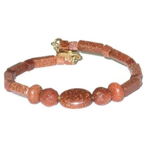 Handcrafted beaded bracelet with goldstone beads on a white background