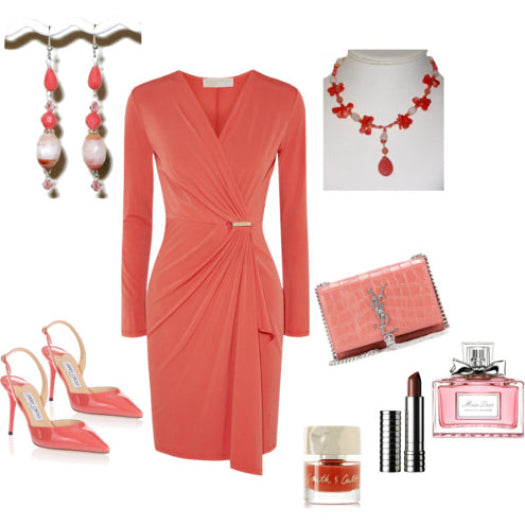 Coral dress with matching accessories including shoes, jewelry, and lip products on a white background