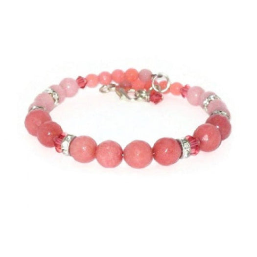 Coral and salmon beaded bracelet with faceted and smooth jade-style gemstone beads, Swarovski crystals, and sparkling rhinestone rondelle beads on a white background