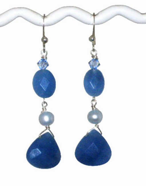 Pair of blue teardrop earrings made with crystals, freshwater pearls and faceted jade-style gemstone beads on a white background