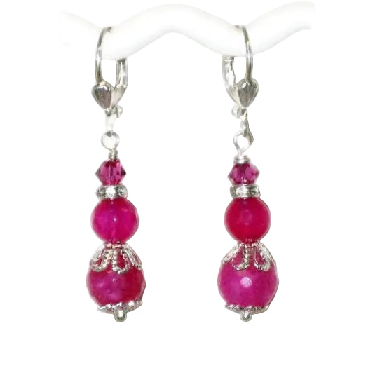 Pair of fuchsia beaded dangle earrings hanging on silver-plated leverbacks on a white background