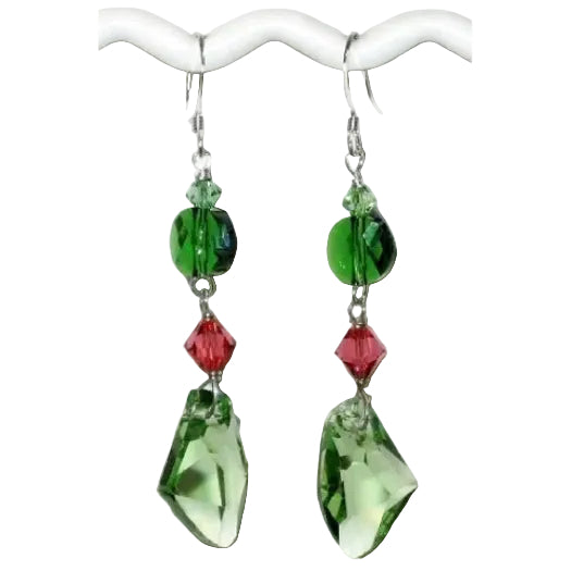 Green and Padparadscha crystal dangle earrings on a white background