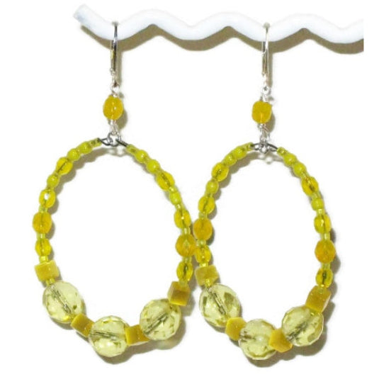 Large yellow beaded hoop earrings on a white background