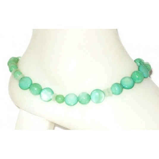 Mint green beaded ankle bracelet on a mannequin foot