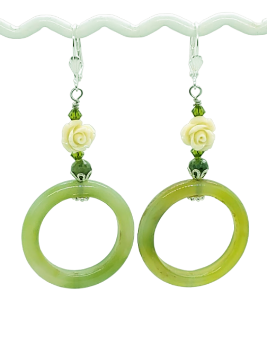 Olive green-colored and cream hoop earrings with a flower accent on the top of each earring. Earrings are displayed on a white background