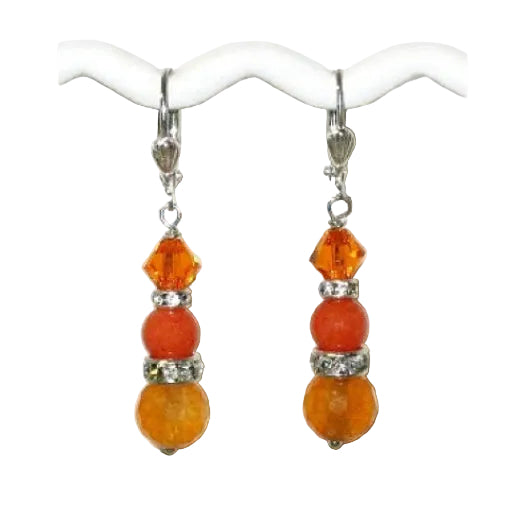Pair of orange beaded drop earrings on a white background