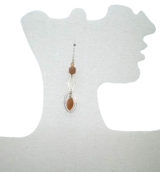 Peach dangle earring with peachy brown moonstone gemstone beads with sterling silver components hanging on a mannequin ear