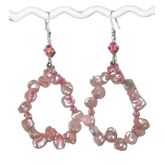 Pair of pink keshi pearl beaded hoop earrings on a white background