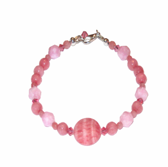 Hancrafted pink beaded bracelet with a silver clasp on a white background