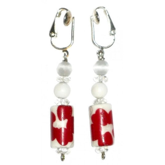 Pair of clip-on earrings with red and white cylindrical beads on a white background