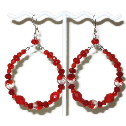Red beaded hoop earrings on a white stand