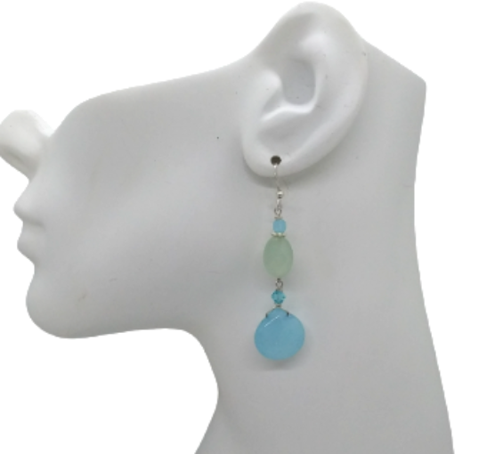 Seafoam and sky blue stylish dangle earrings on mannequin ear