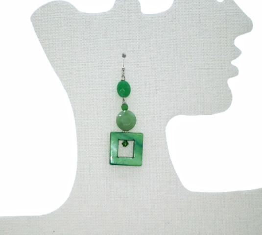 Green beaded dangle earring on a mannequin ear