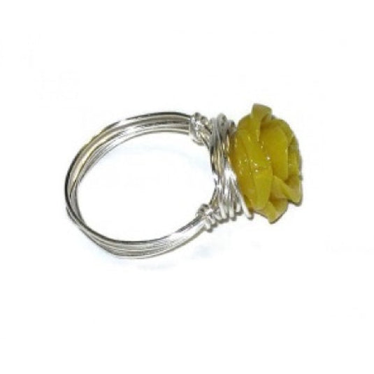 Ring with a yellow carved flower design on a white background