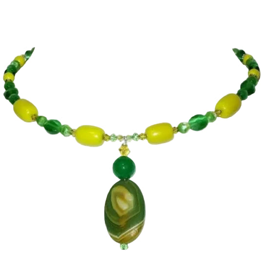 Handmade beaded green and yellow choker style necklace with an agate pendant on a white mannequin bust