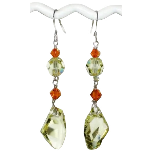 Pair of dangle earrings with yellow and orange Swarovski crystals on a white background