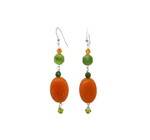 Pair of earrings with orange and lime green beads on a white background