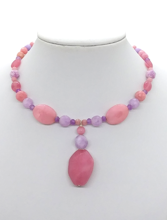 Handmade pink and lilac jade-style gemstone choker necklace on flexible memory wire with a 1 ⅞ inch drop pendant on a white jewelry display.