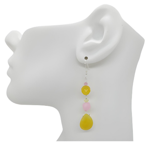 Earring displayed on a mannequin ear with colorful yellow and pink beads.