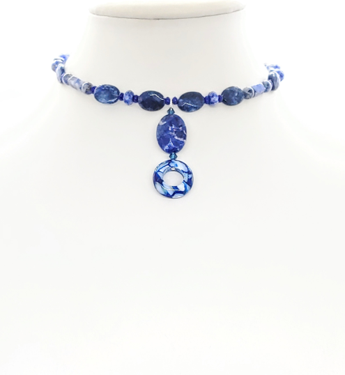 Navy blue beaded choker style necklace with drop pendant on a white mannequin