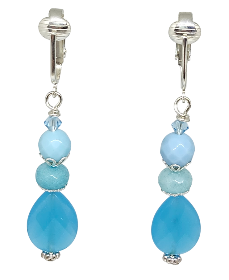 A pair of drop earrings with silver-tone ear clips featuring light blue and aqua blue beads and a small aqua blue crystal.