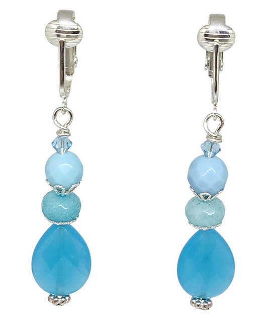 A pair of drop earrings with silver-tone ear clips featuring light blue and aqua blue beads and a small aqua blue crystal.