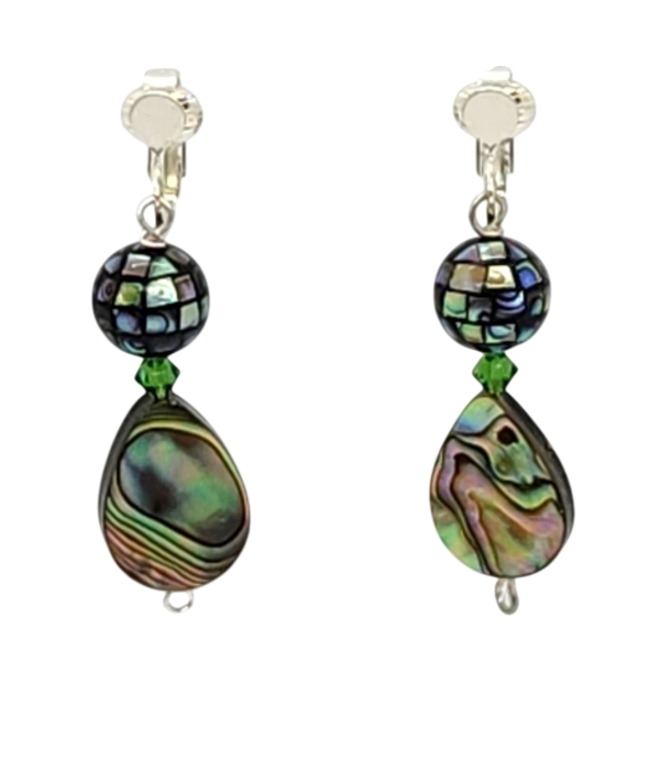 A pair of drop clip-on earrings featuring iridescent abalone shell beads in teardrop and round shapes, accented by green crystals and silver-tone ear clips.