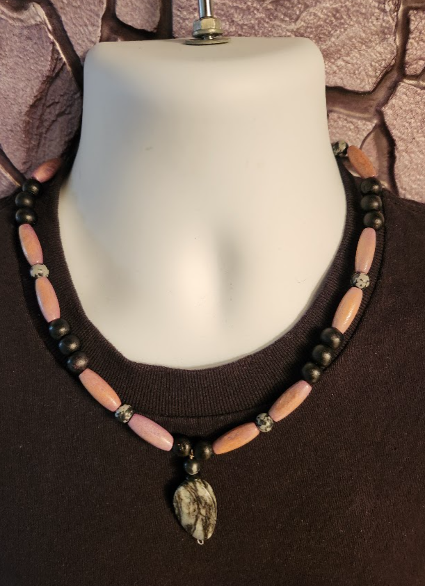 Men's black and light purple beaded necklace with wood and zebra jasper pendant.