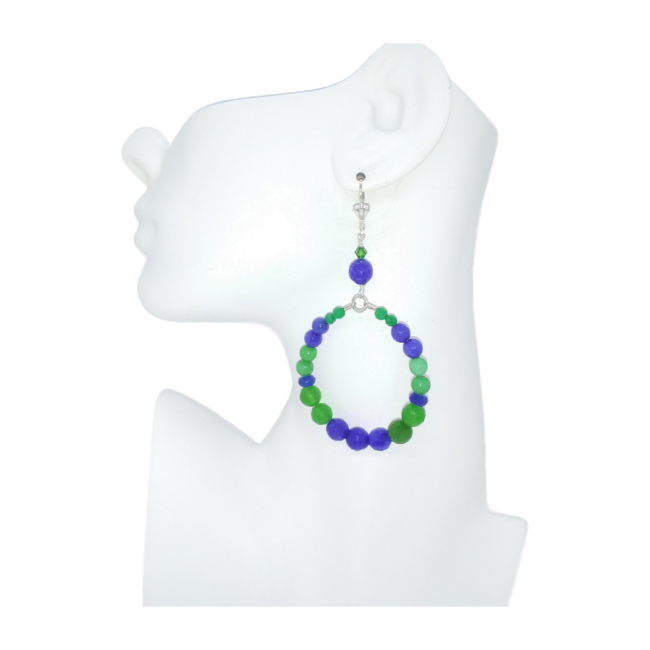 Vibrant blue and green beaded hoop earring on a white mannequin ear with a white background