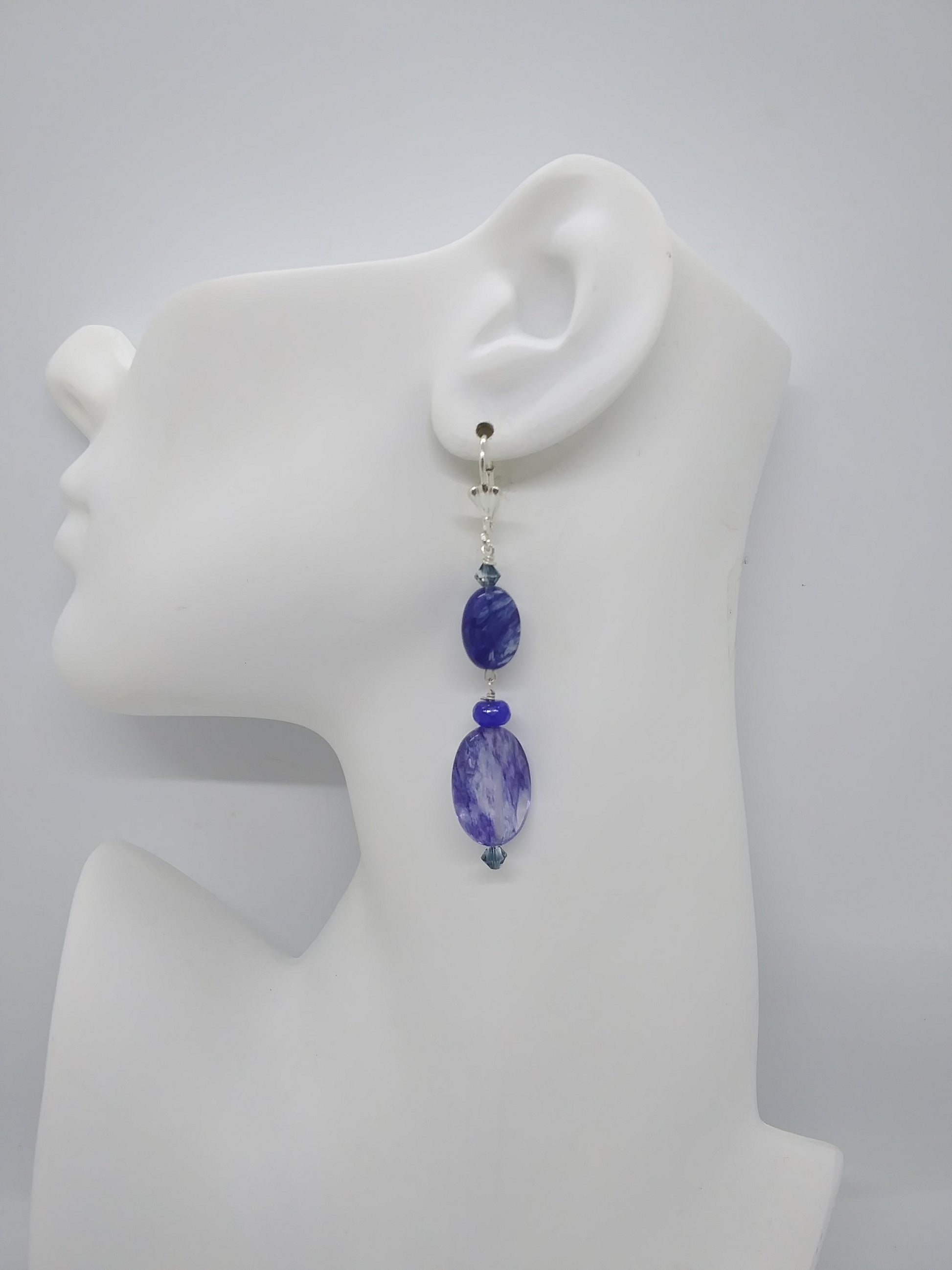 Earring with blue beads on a white ear mannequin model

