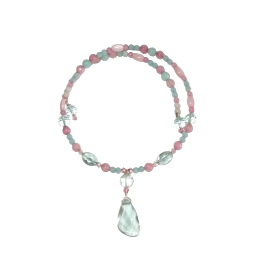 An expandable blush pastel pink and aqua beaded choker with a faceted aqua quartz pendant on a crisp white background.
