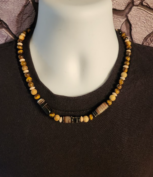 Men's brown, beige, and black beaded necklace composed of wood beads and semi-precious stones.