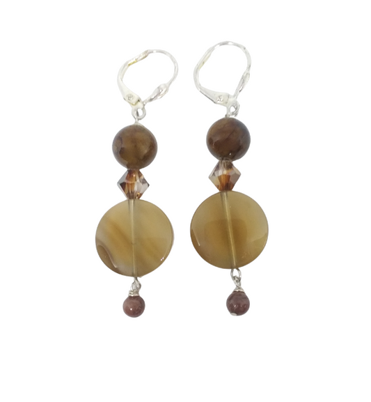 A pair of dangle earrings featuring a polished brown agate disc bead smaller round brown beads, clear faceted crystal accents, and silver leverback hooks, shown against a plain white background.