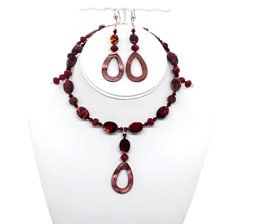 Cranberry and burgundy beaded choker  and earrings set on a white mannequin bust.