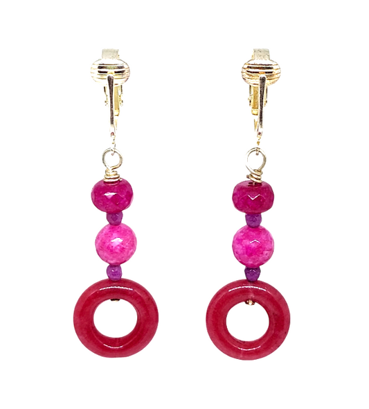 Fuchsia and purple jade clip-on earrings with faceted and donut-shaped beads.