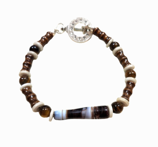 A men's beaded bracelet featuring dark brown and light brown beads, light beige spacer beads, a central striped black, white, and brown agate bead, and a silver-toned clock-shaped toggle clasp, shown on a plain white background.
