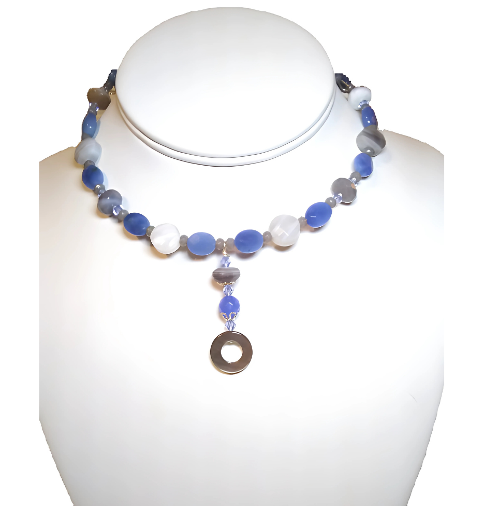 Choker with blue and white beads on a mannequin bust against a white background

