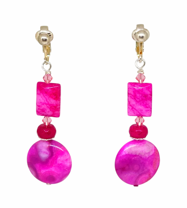 A pair of drop clip-on earrings with silver-tone clips, featuring bright pink marbled rectangular and round beads, and small pink faceted crystals, shown on a plain white background.