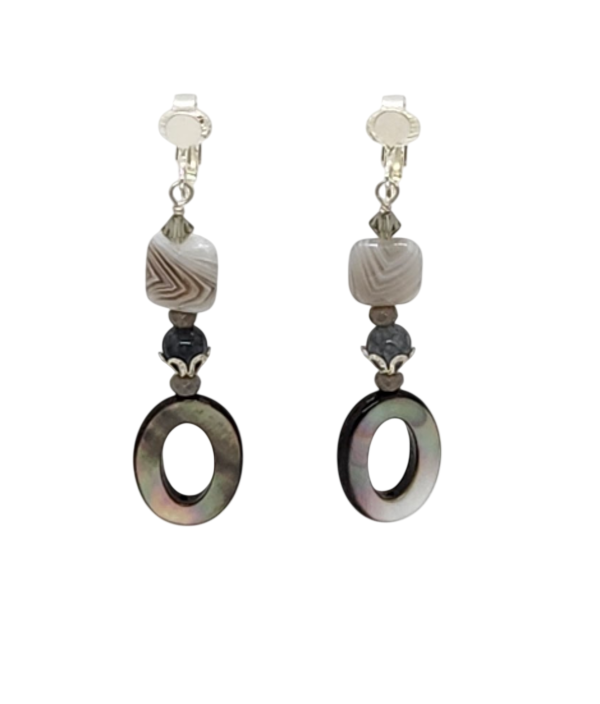 A pair of drop earrings with silver-tone ear clips featuring semi-precious stones, gray crystals and oval ring shell beads.