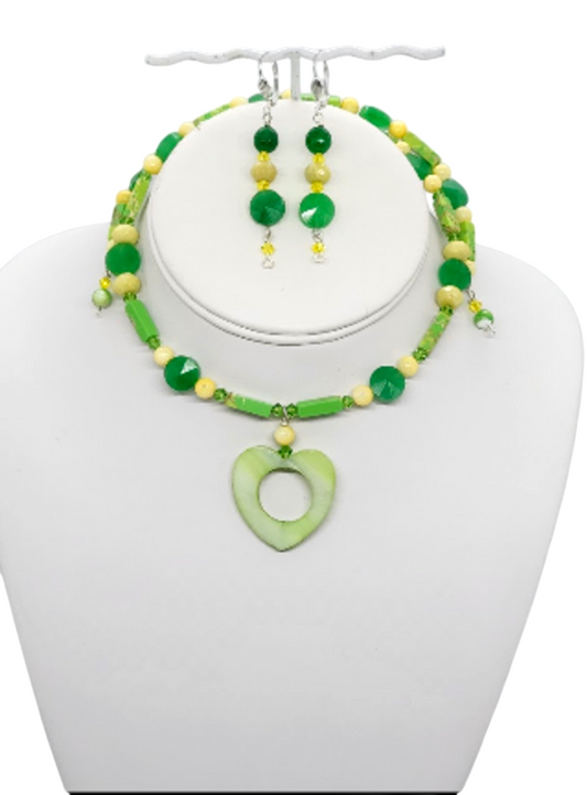 Green and yellow beaded choker-style necklace and matching drop earrings displayed on a white jewelry bust against a white background.