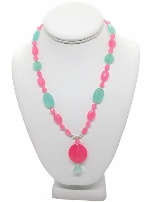 Necklace with pink and aqua beads on a white mannequin bust