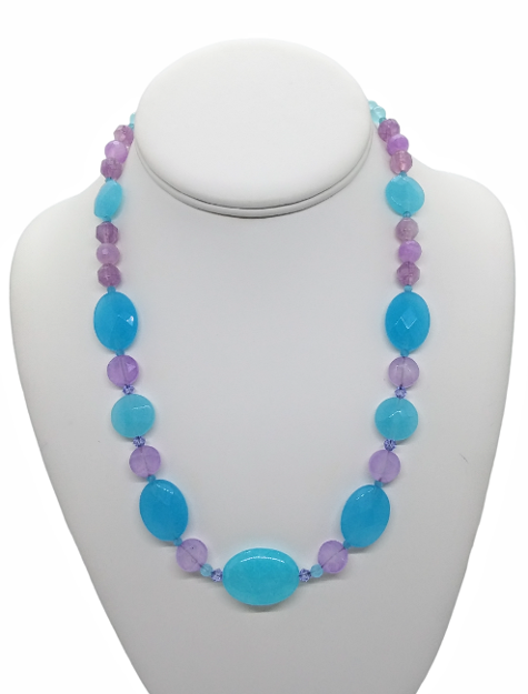 Necklace with blue and purple beads on a white mannequin