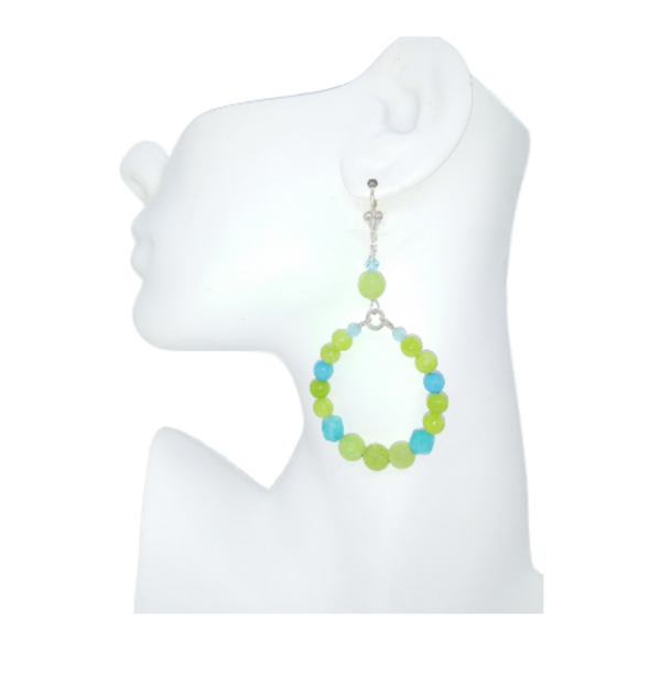 lime green and aqua beaded hoop earrings on a mannequin ear on white background