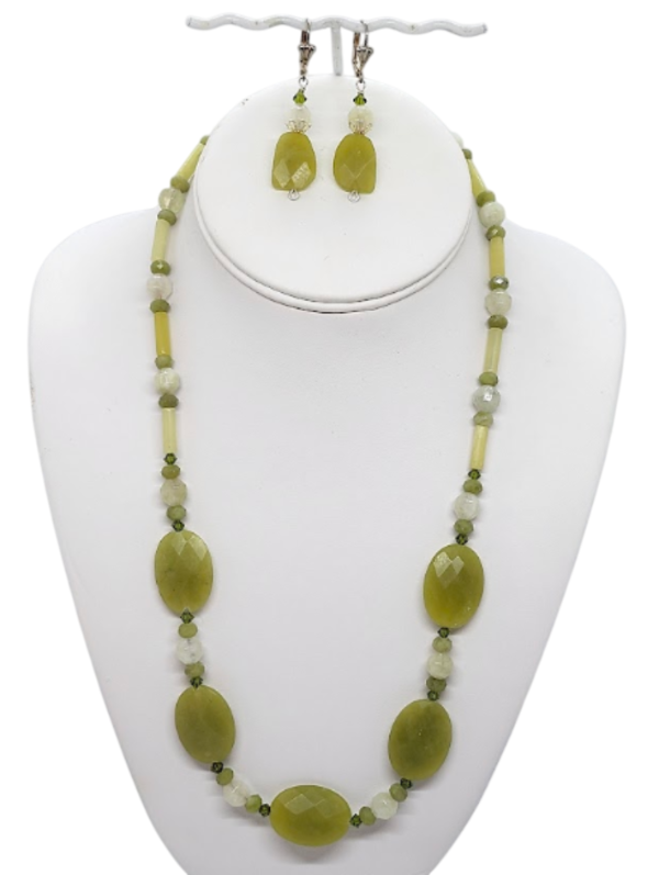An olive and chartreuse necklace with matching earrings.  The set is composed of semi-precious stones.  The necklace is 21 inches and the earrings hang 1-1/2 inches from silvertone leverback earwires.    The necklace set is on a white bust display.  