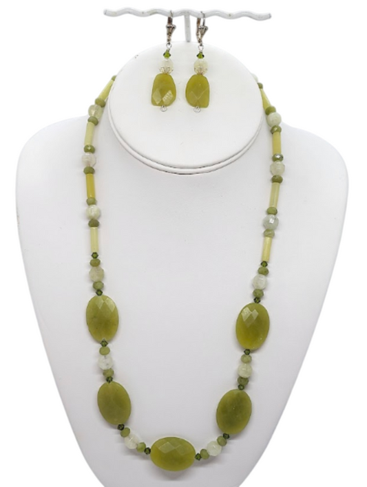 An olive and chartreuse necklace with matching earrings.  The set is composed of semi-precious stones.  The necklace is 21 inches and the earrings hang 1-1/2 inches from silvertone leverback earwires.    The necklace set is on a white bust display.  