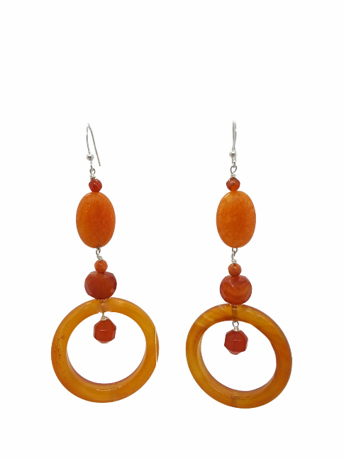Pair of orange hoop dangle earrings on a white background