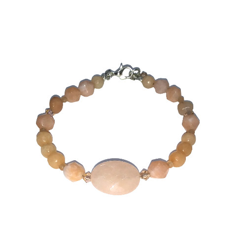 Bracelet with peach-colored beads on a white background