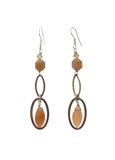 Pair of earrings with peach beads and sterling silver oval designs on a white background