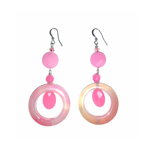 Pair of pink dangle hoop earrings on a white background